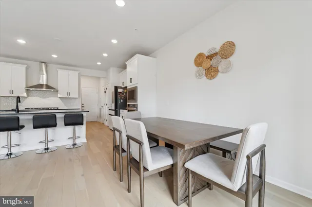 a kitchen with a table and chairs in it