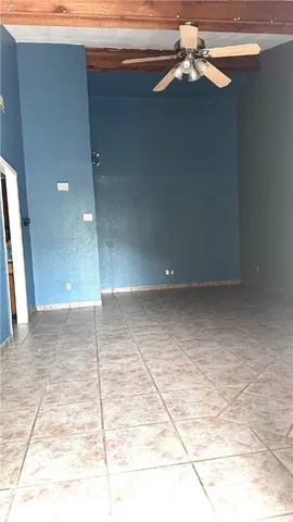 a view of a big room with a chandelier fan