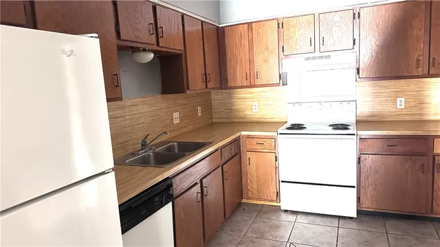 a kitchen with a refrigerator and a sink