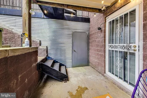 a backyard of a house with barbeque oven table and chairs
