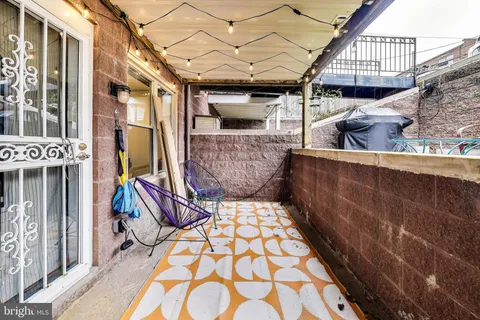 a view of an outdoor sitting area with brick walls
