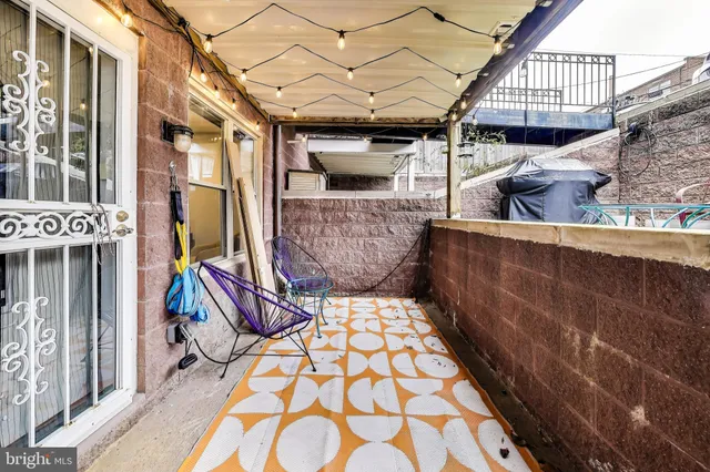 a view of an outdoor sitting area with brick walls