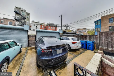 a view of a brick building next to a large building