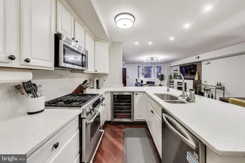 a kitchen with a stove a sink and a refrigerator