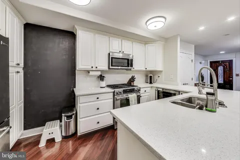 a kitchen with a stove a sink and a refrigerator