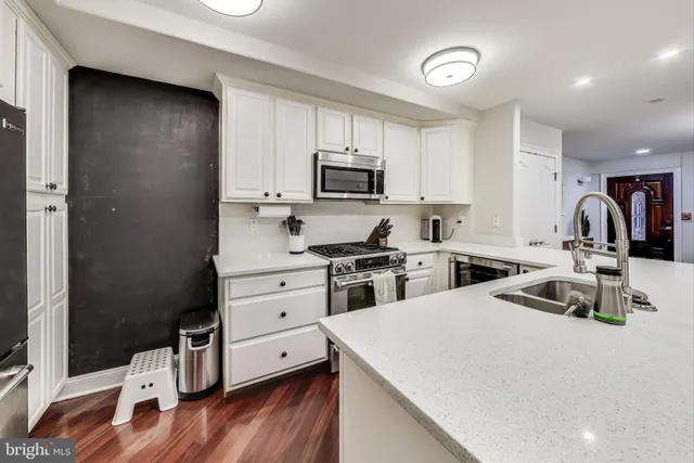 a kitchen with a stove a sink and a refrigerator
