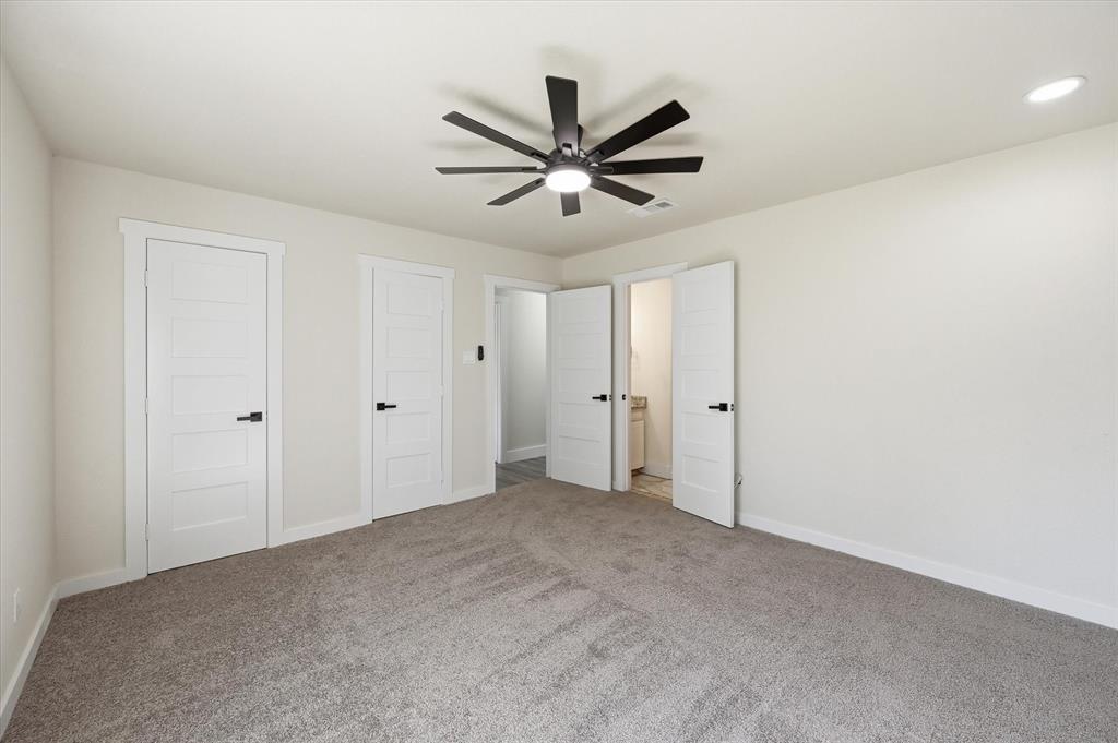 2804 Bent Tree Lane Arlington, TX 76016 - Photo 21 of 32 a view of a livingroom with a ceiling fan & windows