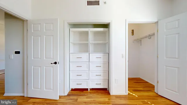 a view of walk in closet with empty racks