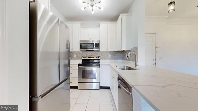 a kitchen with a sink appliances and cabinets