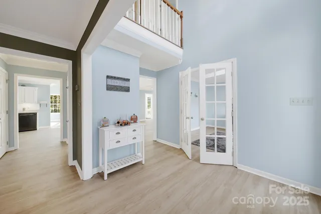 wooden floor with white walls and windows