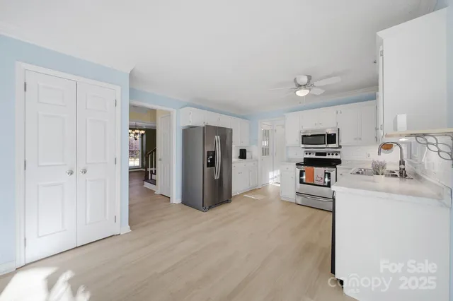 a kitchen with stainless steel appliances a refrigerator and a stove top oven