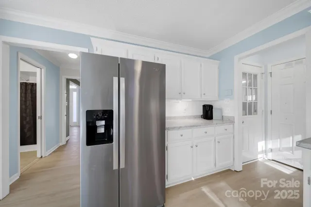 a kitchen with stainless steel appliances a refrigerator sink and cabinets