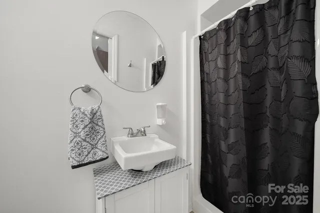 a bathroom with a granite countertop sink and mirror