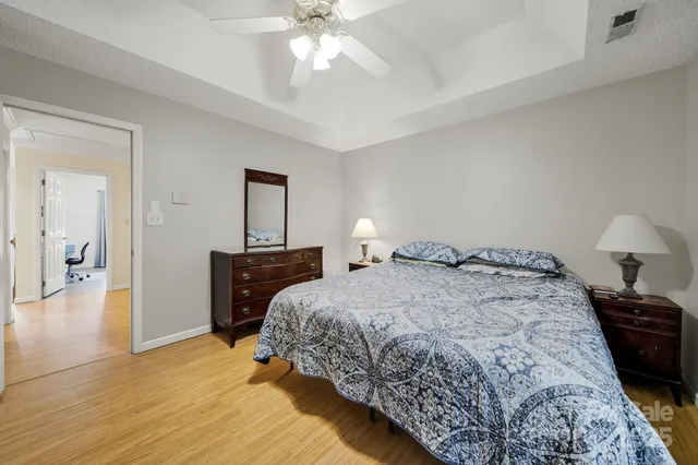 a bedroom with a bed and a chandelier