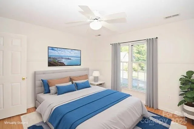 a bedroom with a bed and a painting on the wall