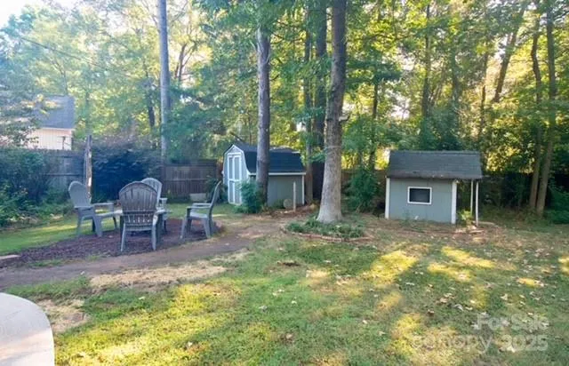 a view of a house with a yard and sitting area