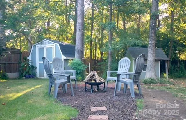a view of a wooden chairs and bench in the garden