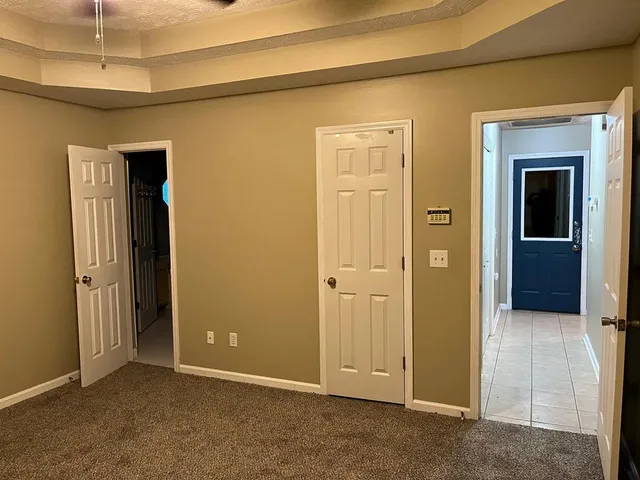 a spacious bathroom with a granite countertop sink and mirror