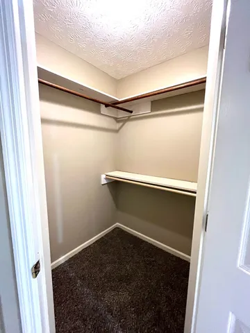 a spacious bathroom with a granite countertop sink a toilet a mirror and vanity