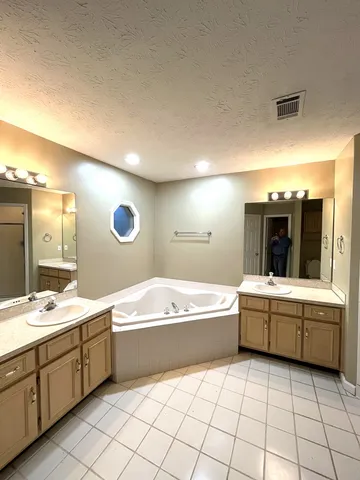 a bathroom with a sink vanity and a mirror