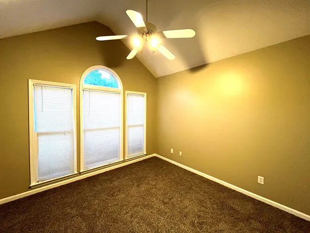 a view of a big house with a big yard and large trees