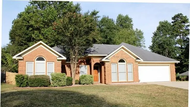 a view of a house with a yard covered in snow