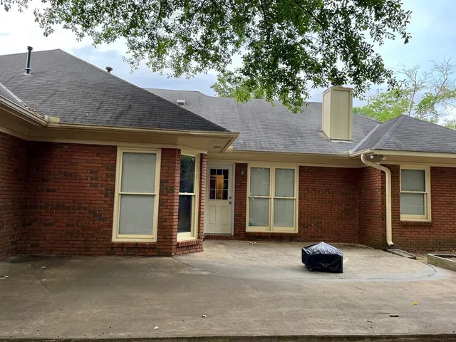 a backyard of a house with lots of green space and lake view