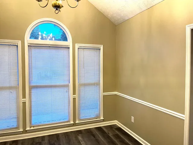 a kitchen with a sink a refrigerator and cabinets