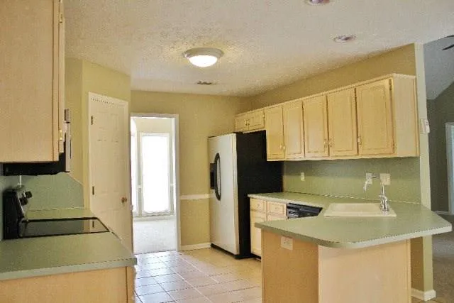 a kitchen with stainless steel appliances granite countertop a sink a stove and a microwave