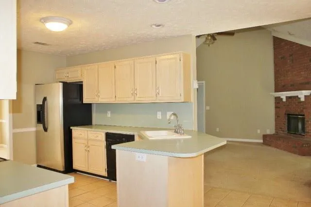 a view of a room with an empty space and chandelier