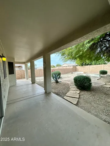 a view of a porch with furniture and floor to ceiling window