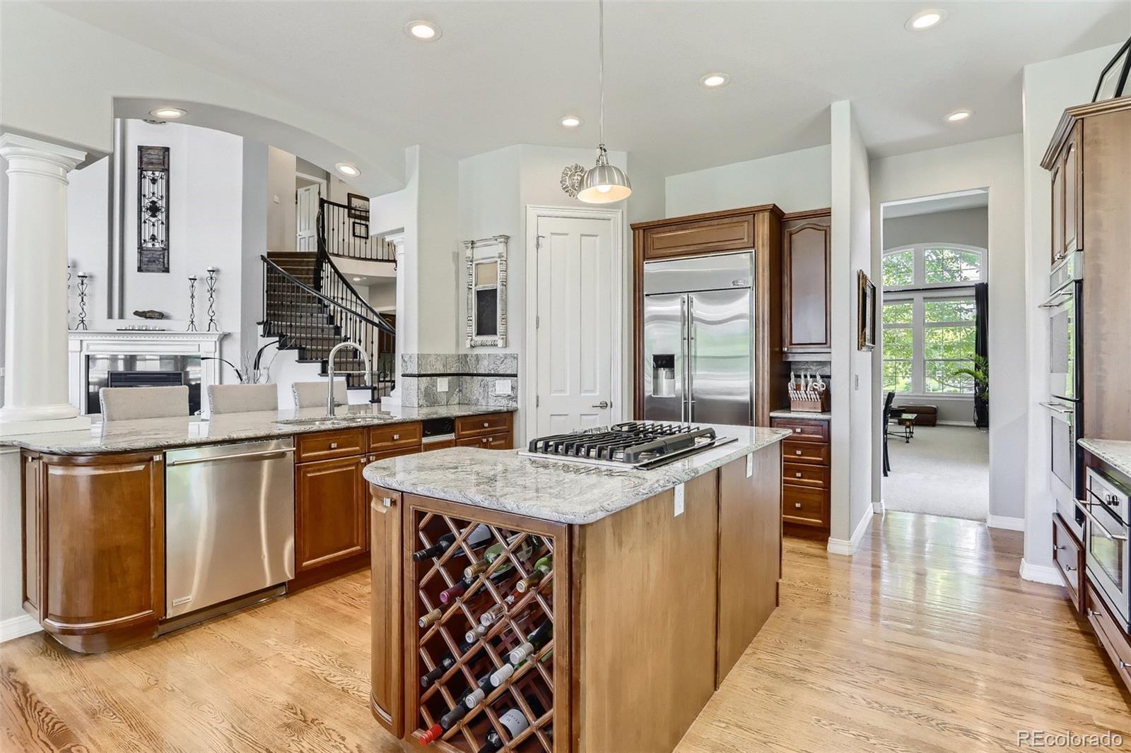 10189 Longview Drive Lone Tree, CO 80124 - Photo 11 of 40 a kitchen with stainless steel appliances granite countertop a sink stove and refrigerator