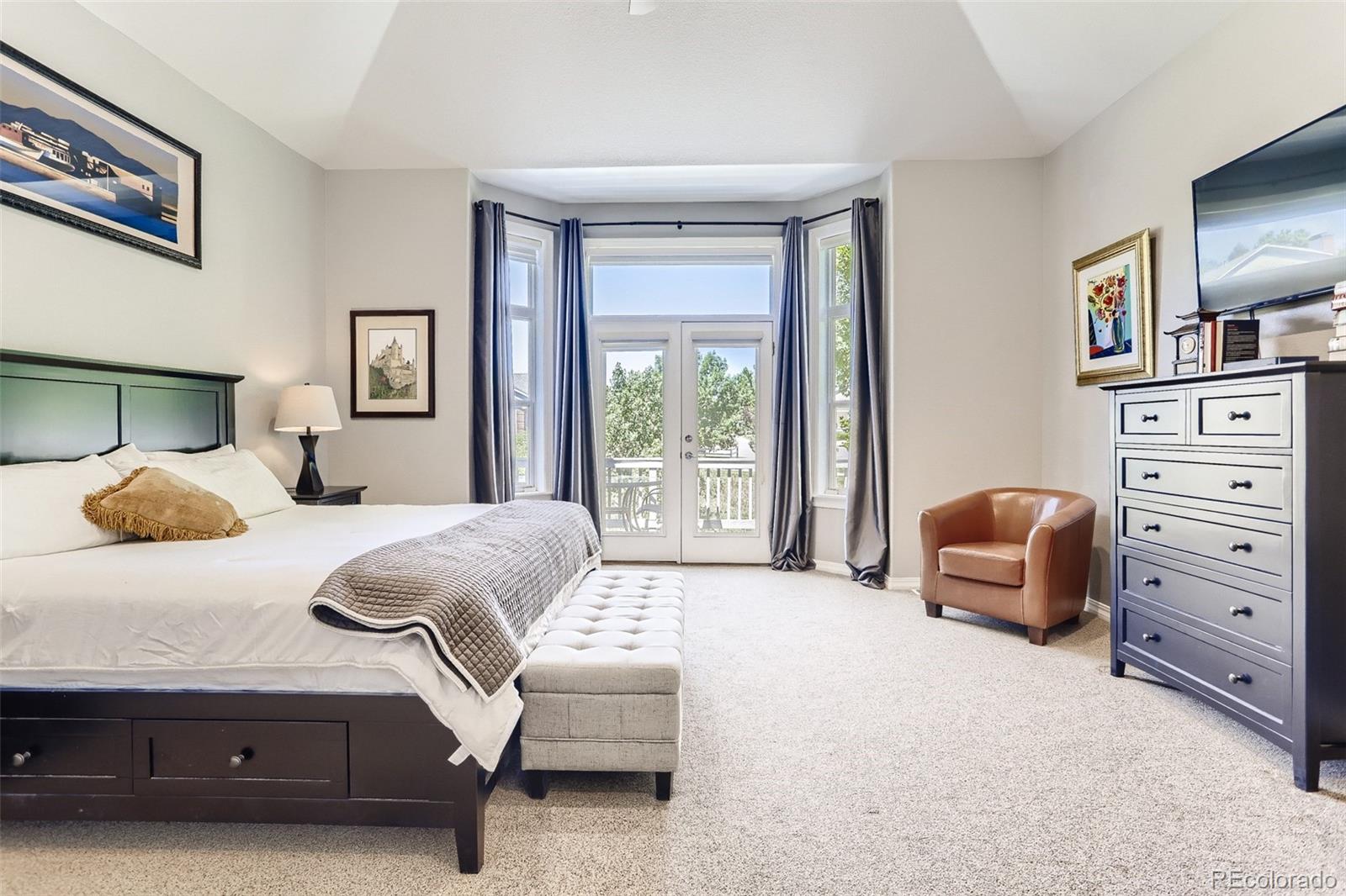 10189 Longview Drive Lone Tree, CO 80124 - Photo 17 of 40 a bedroom with a bed and a couch