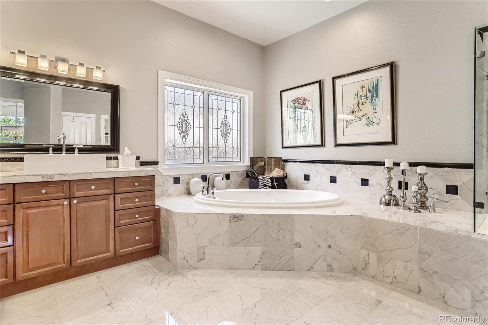10189 Longview Drive Lone Tree, CO 80124 - Photo 20 of 40 a spacious bathroom with a tub sink and mirror
