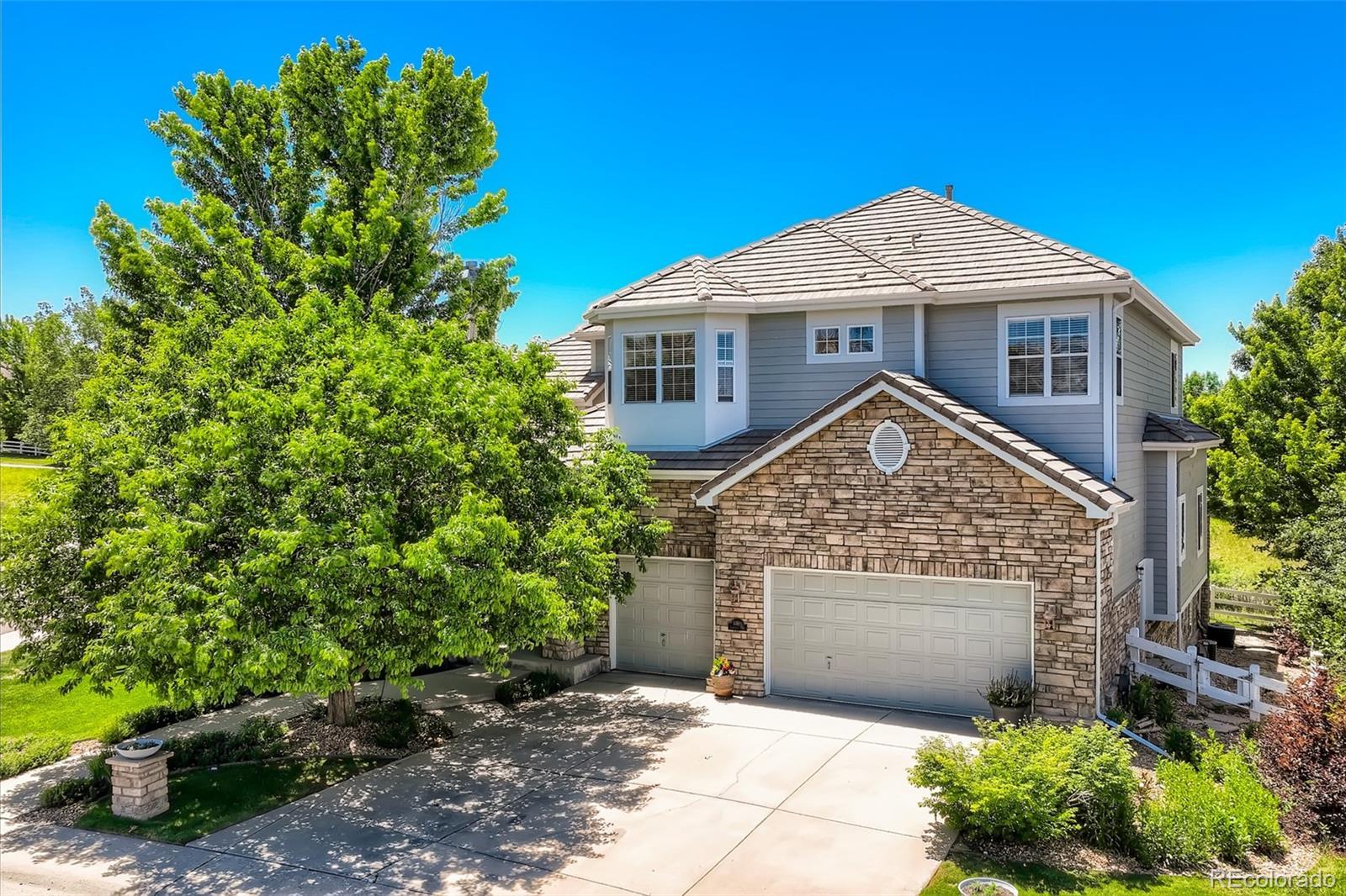 10189 Longview Drive Lone Tree, CO 80124 - Photo 2 of 40 a front view of a house with a garden