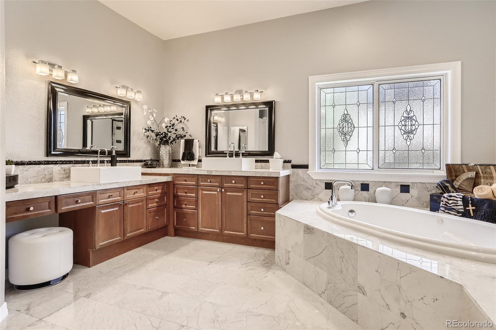 10189 Longview Drive Lone Tree, CO 80124 - Photo 21 of 40 a spacious bathroom with a granite countertop sink and a large mirror