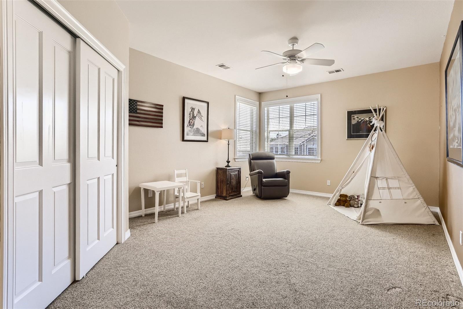 10189 Longview Drive Lone Tree, CO 80124 - Photo 28 of 40 a living room with furniture and a chandelier