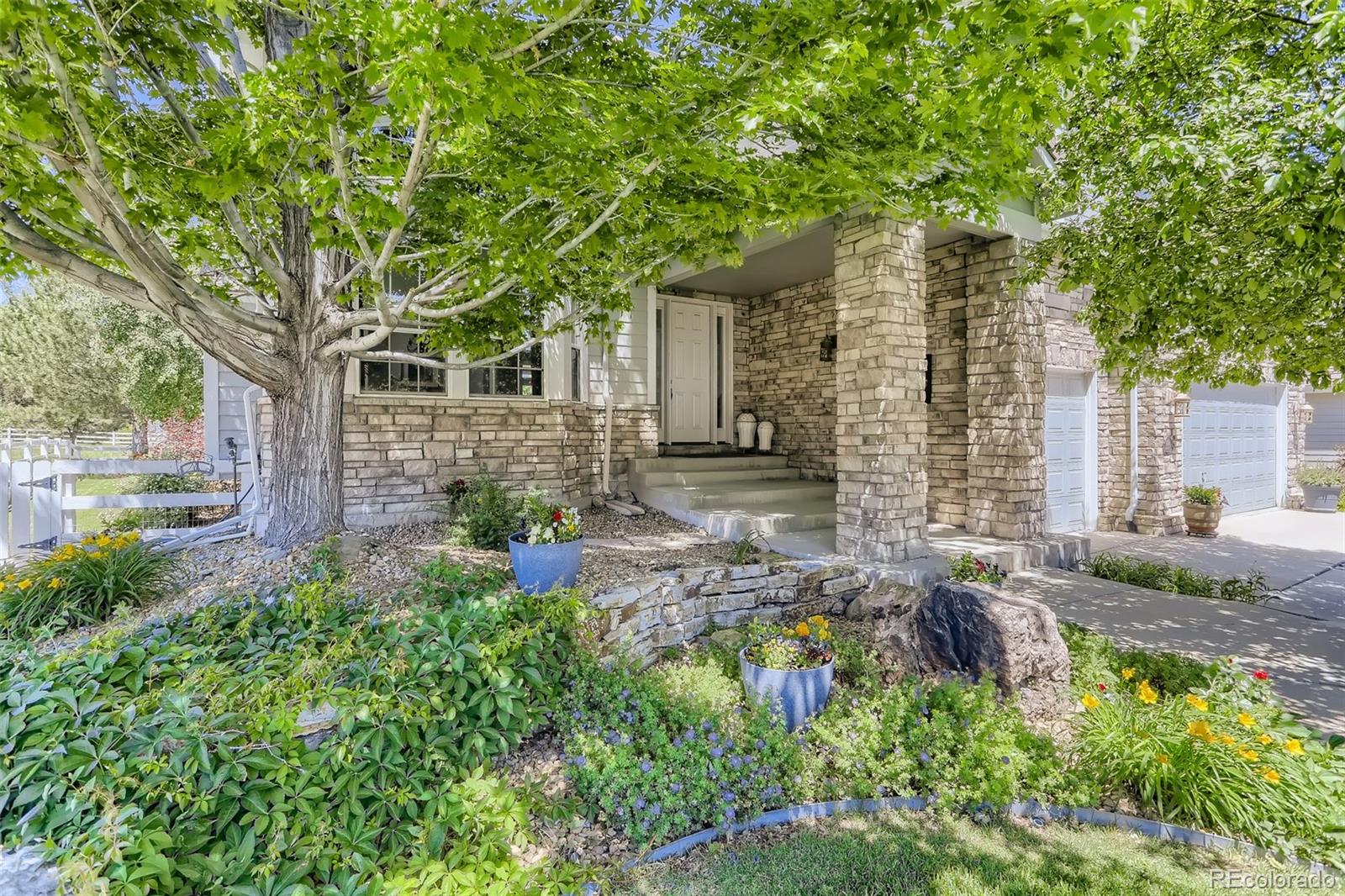 10189 Longview Drive Lone Tree, CO 80124 - Photo 3 of 40 front view of a house with a tree