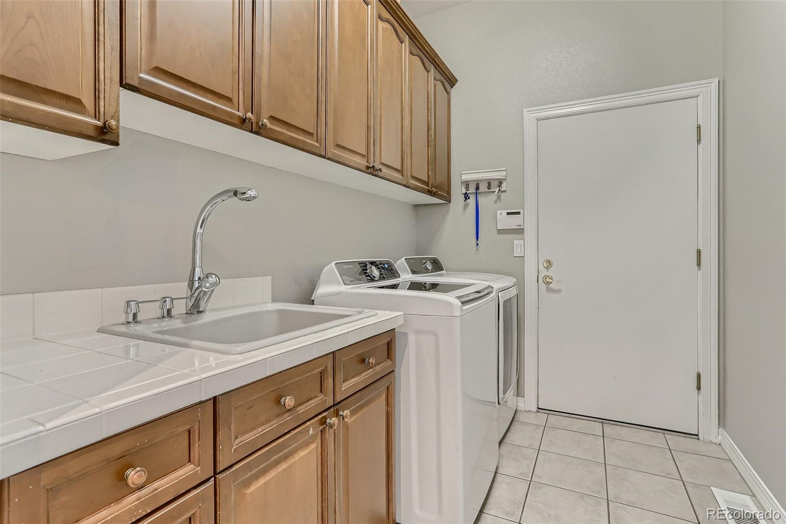 10189 Longview Drive Lone Tree, CO 80124 - Photo 33 of 40 a utility room with sink dryer and washer