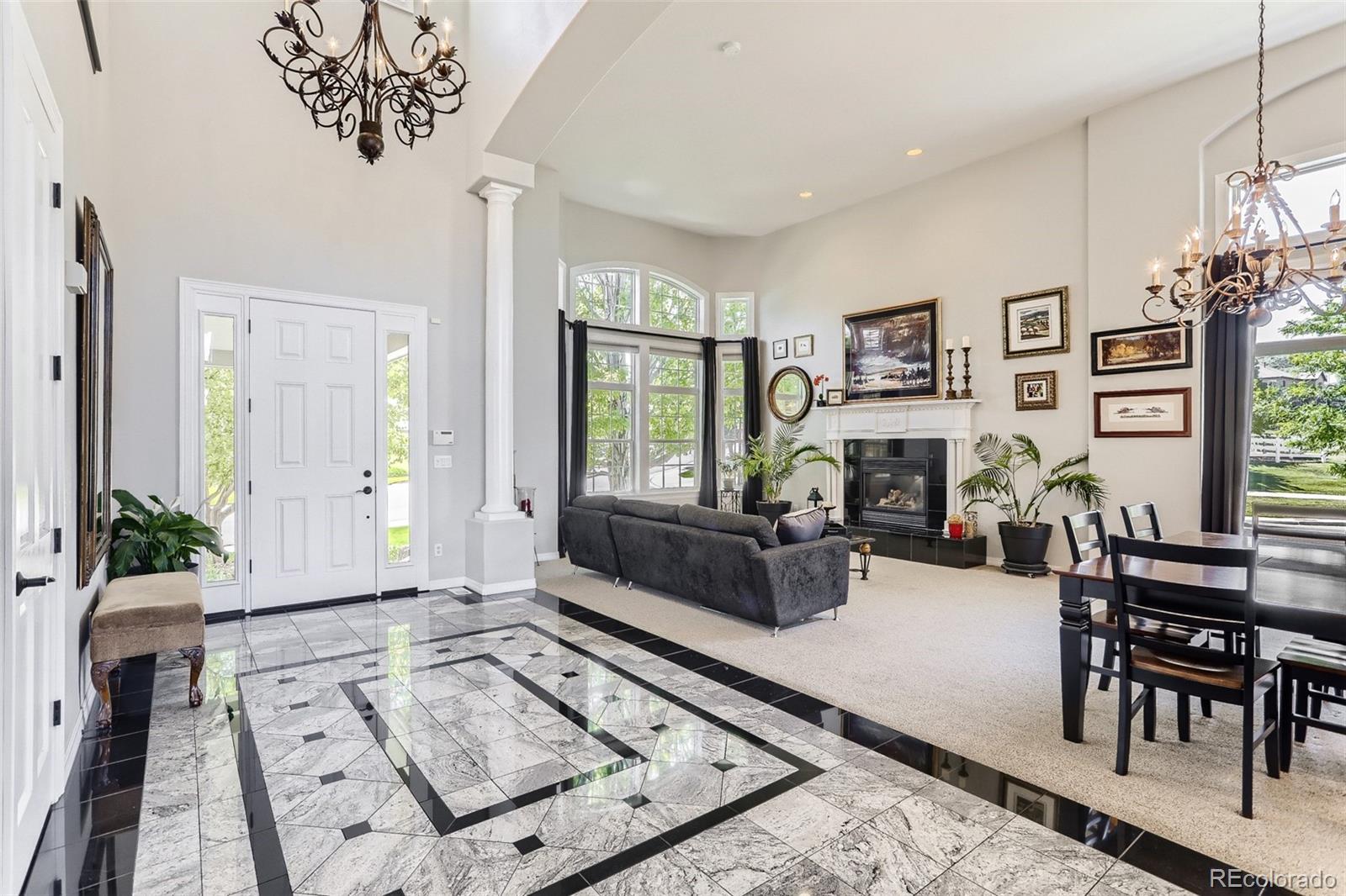 10189 Longview Drive Lone Tree, CO 80124 - Photo 4 of 40 a living room with furniture large window and flat screen tv