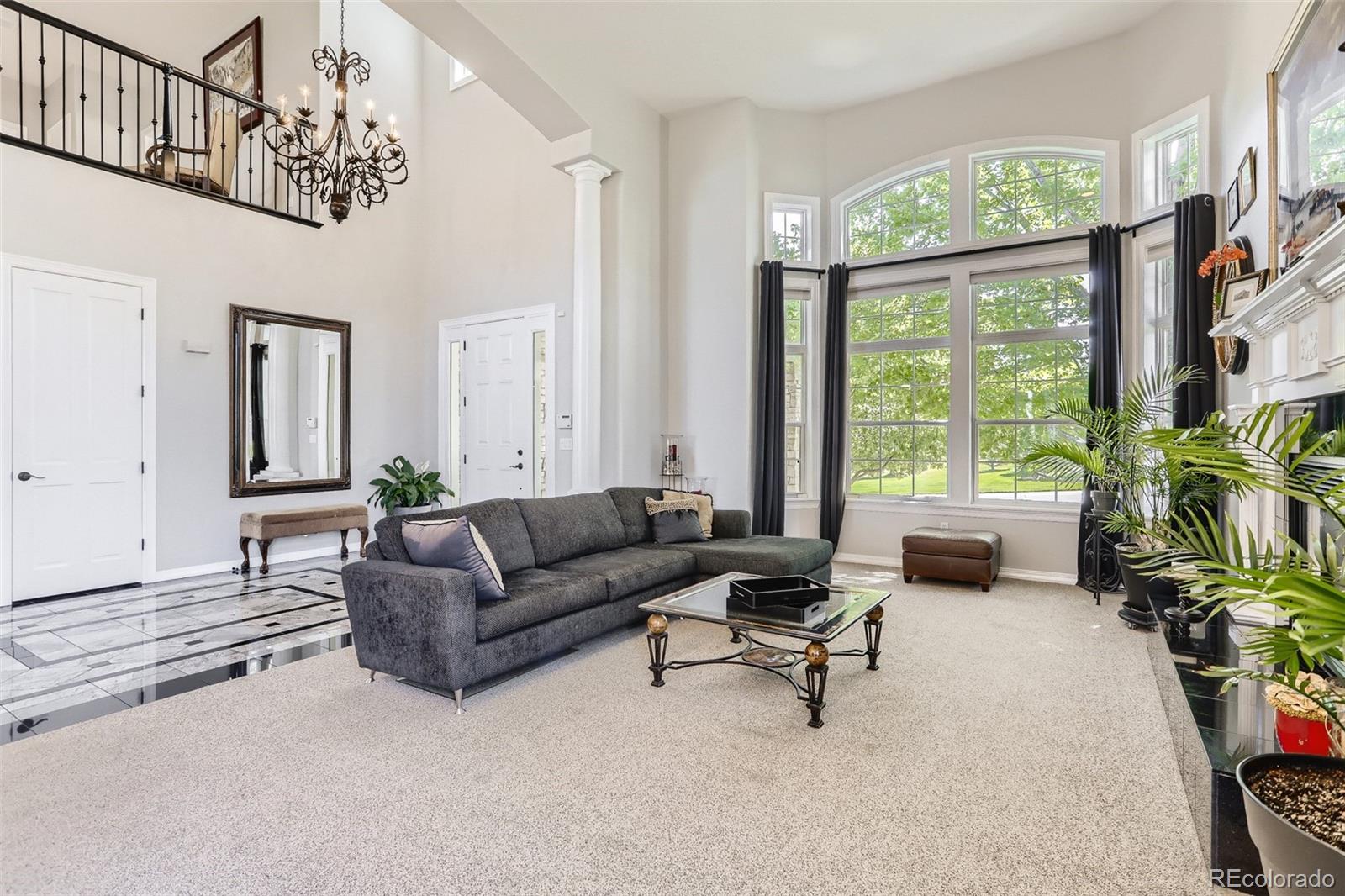 10189 Longview Drive Lone Tree, CO 80124 - Photo 6 of 40 a living room with furniture and a large window
