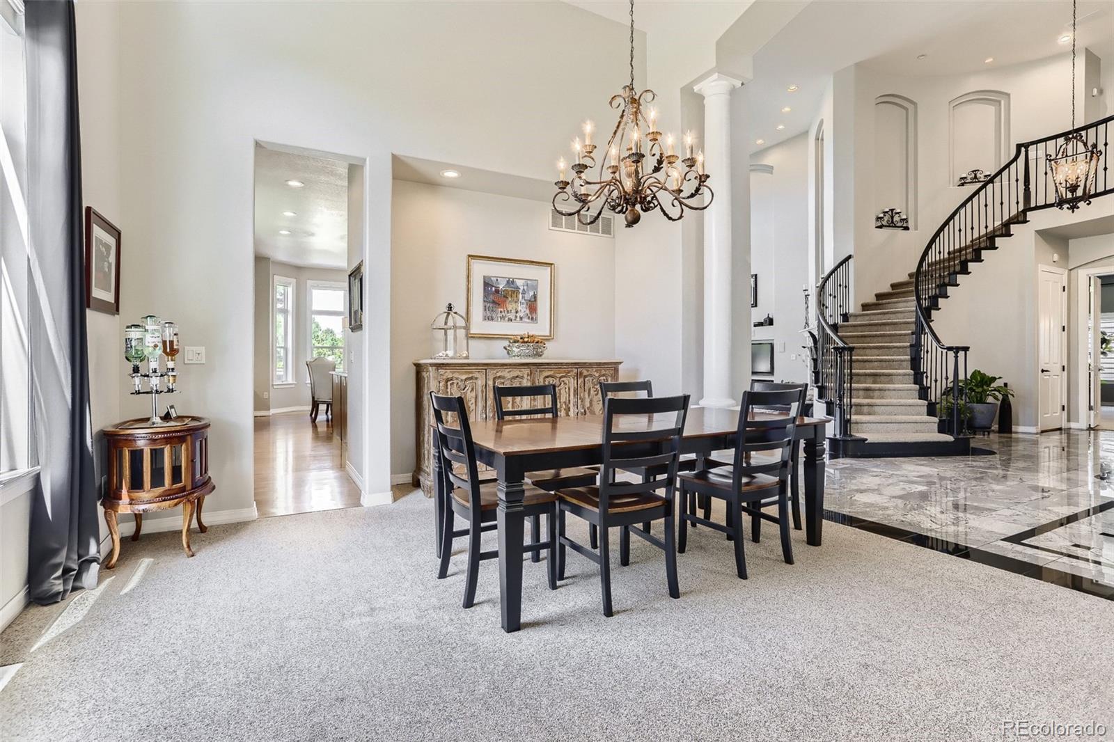 10189 Longview Drive Lone Tree, CO 80124 - Photo 8 of 40 a view of a dining room with furniture and chandelier