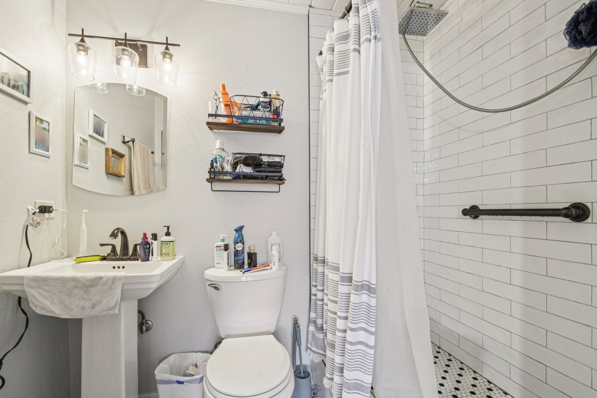 2108 River Hills Road Austin, TX 78733 - Photo 11 of 35 a bathroom with a sink a toilet and shower curtain