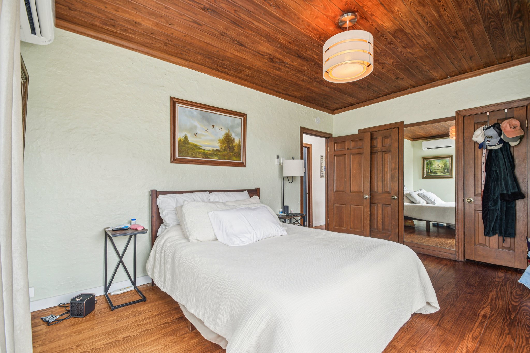 2108 River Hills Road Austin, TX 78733 - Photo 13 of 35 a bedroom with a bed and a chandelier