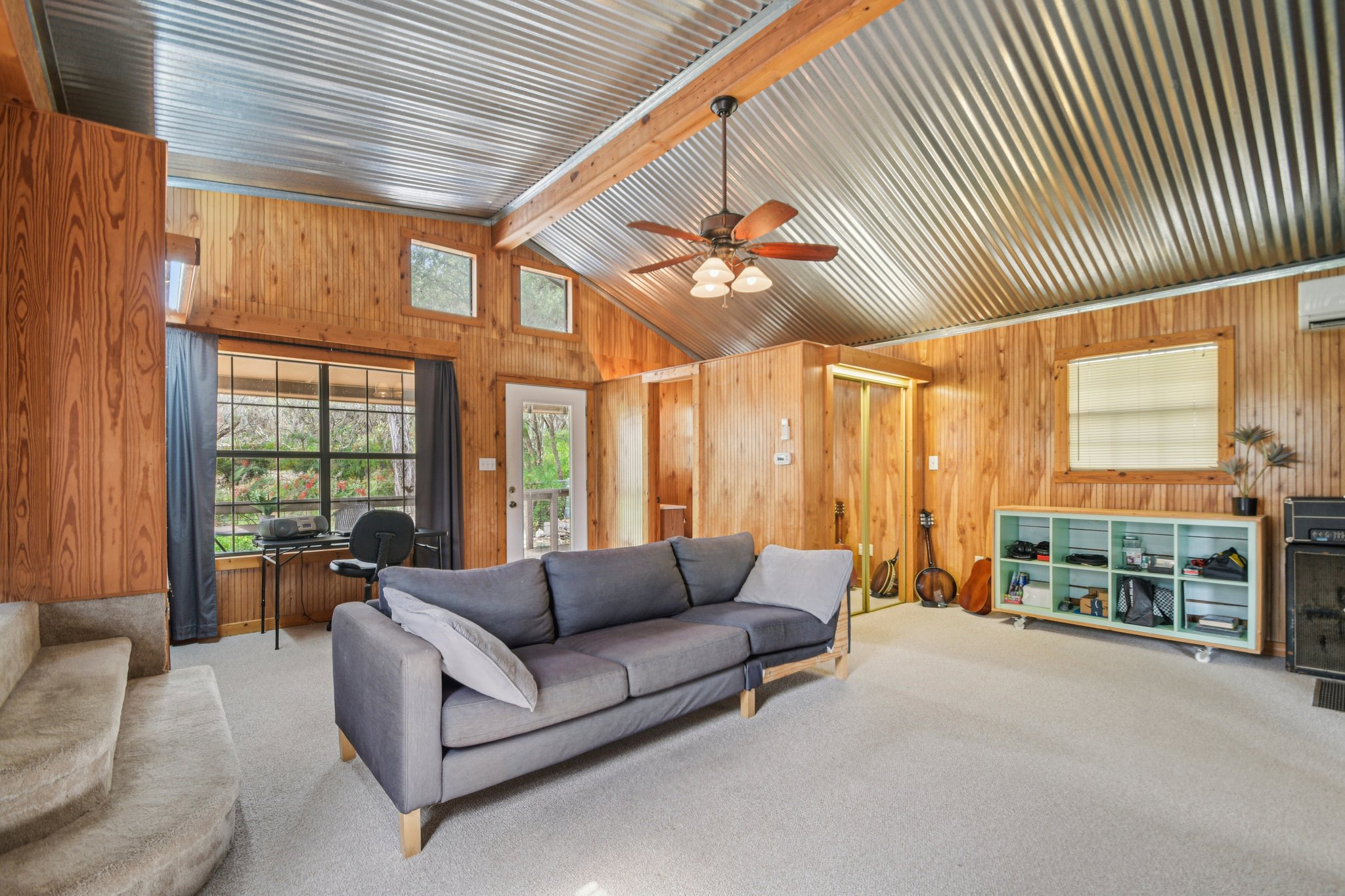 2108 River Hills Road Austin, TX 78733 - Photo 19 of 35 a living room with furniture a ceiling fan and a large window