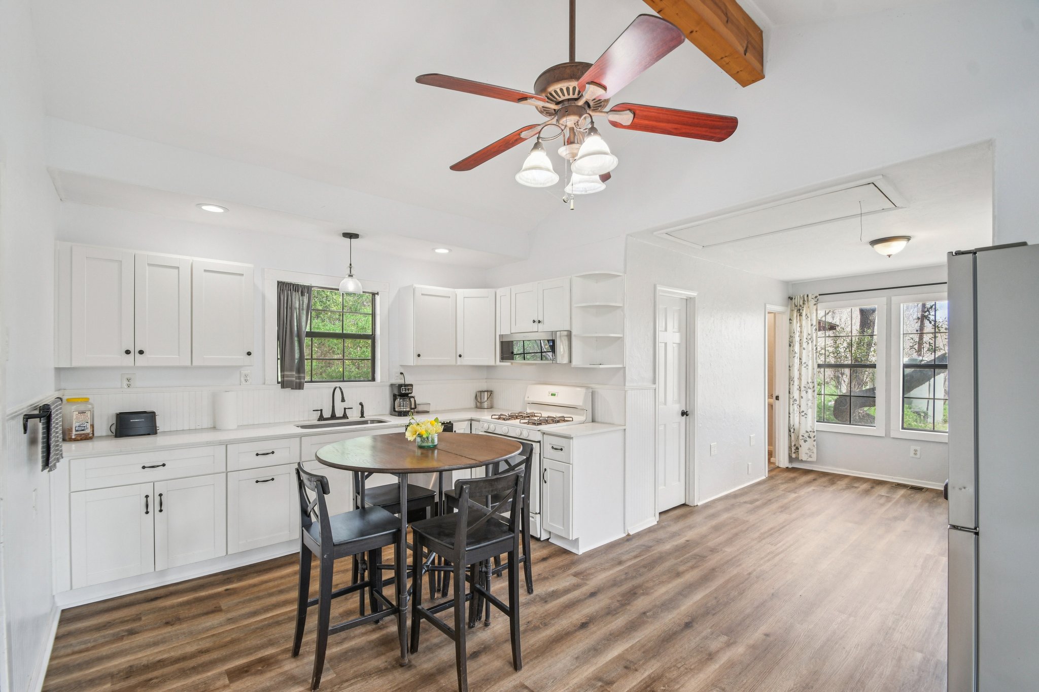 2108 River Hills Road Austin, TX 78733 - Photo 20 of 35 a kitchen with a dining table chairs cabinets and stainless steel appliances
