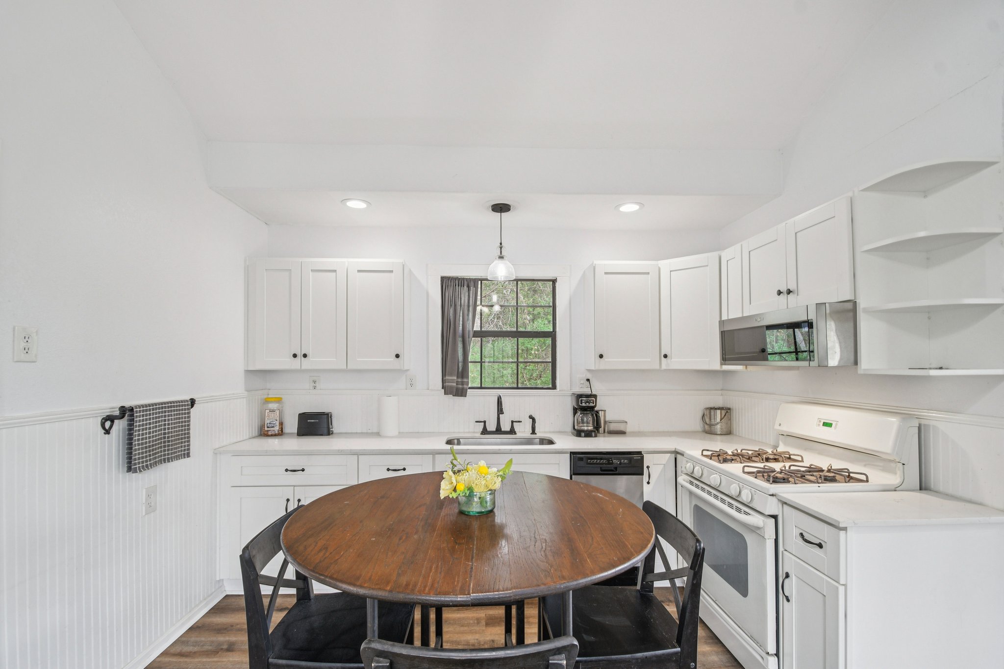 2108 River Hills Road Austin, TX 78733 - Photo 21 of 35 a kitchen that has a lot of cabinets in it with stainless steel appliances