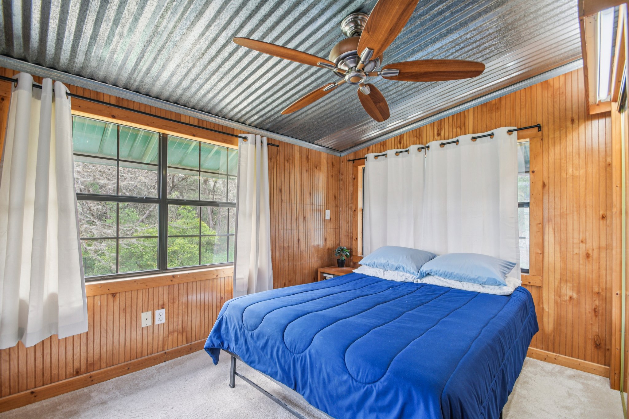 2108 River Hills Road Austin, TX 78733 - Photo 23 of 35 a bedroom with a large bed and a window