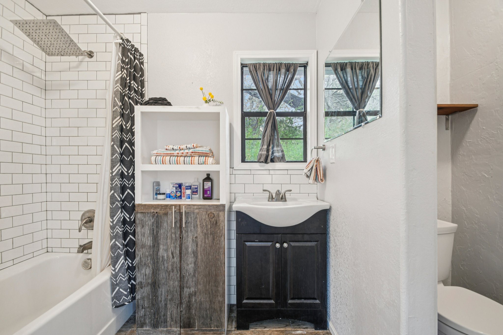 2108 River Hills Road Austin, TX 78733 - Photo 24 of 35 a bathroom with a sink a toilet and shower