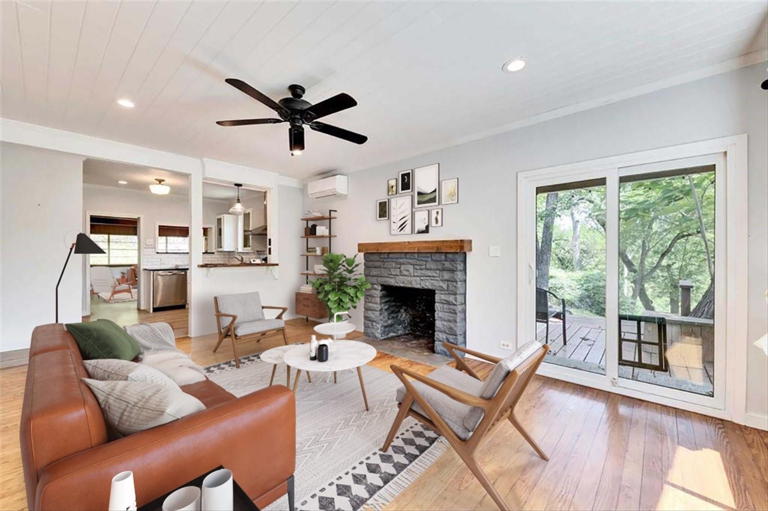 2108 River Hills Road Austin, TX 78733 - Photo 34 of 35 a living room with furniture a fireplace and a floor to ceiling window